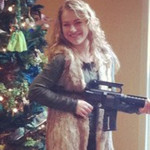 posing with a christmas gift gun